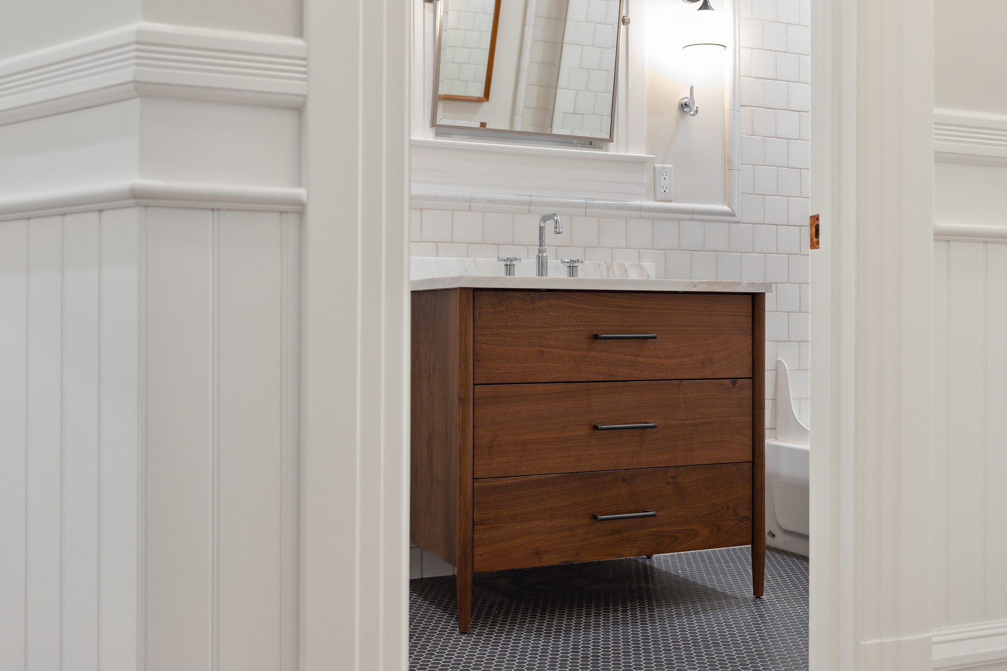 View of a renovated bathroom with wood vanity in a historic San Francisco home